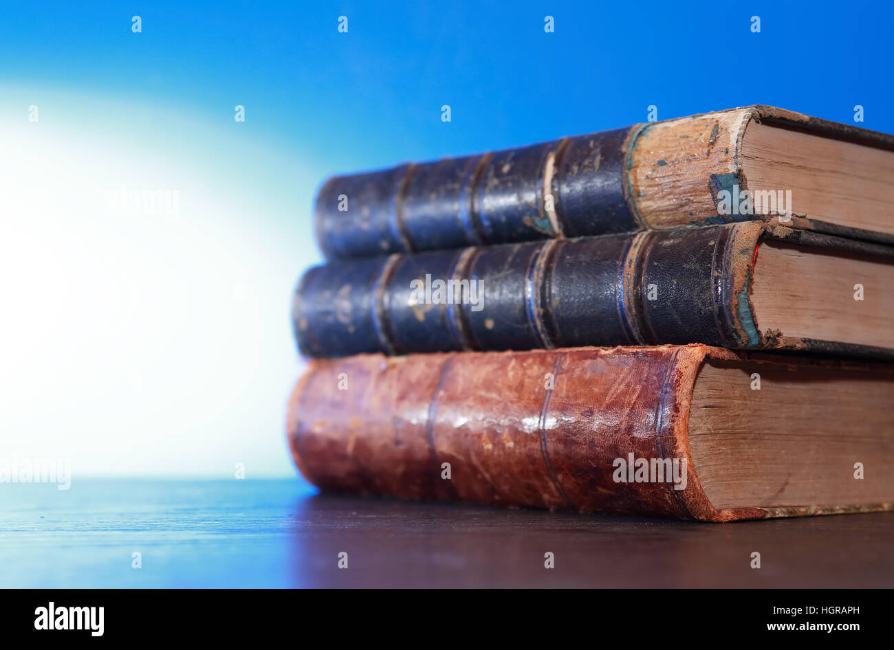 Stack of old books on blue background with free space Stock Photo - Alamy