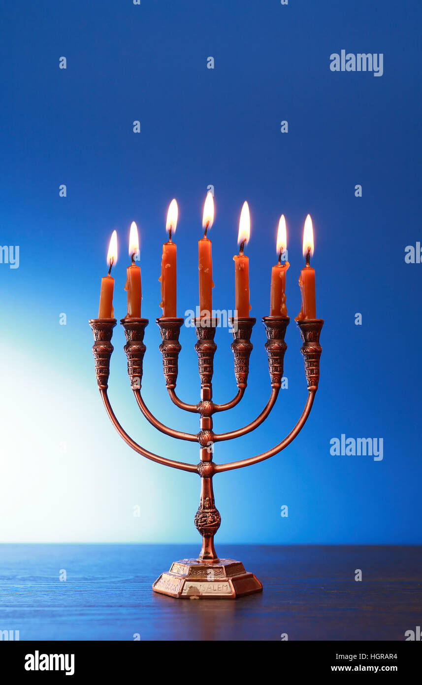 Traditional jewish menorah with lighting candles on nice blue background Stock Photo Alamy