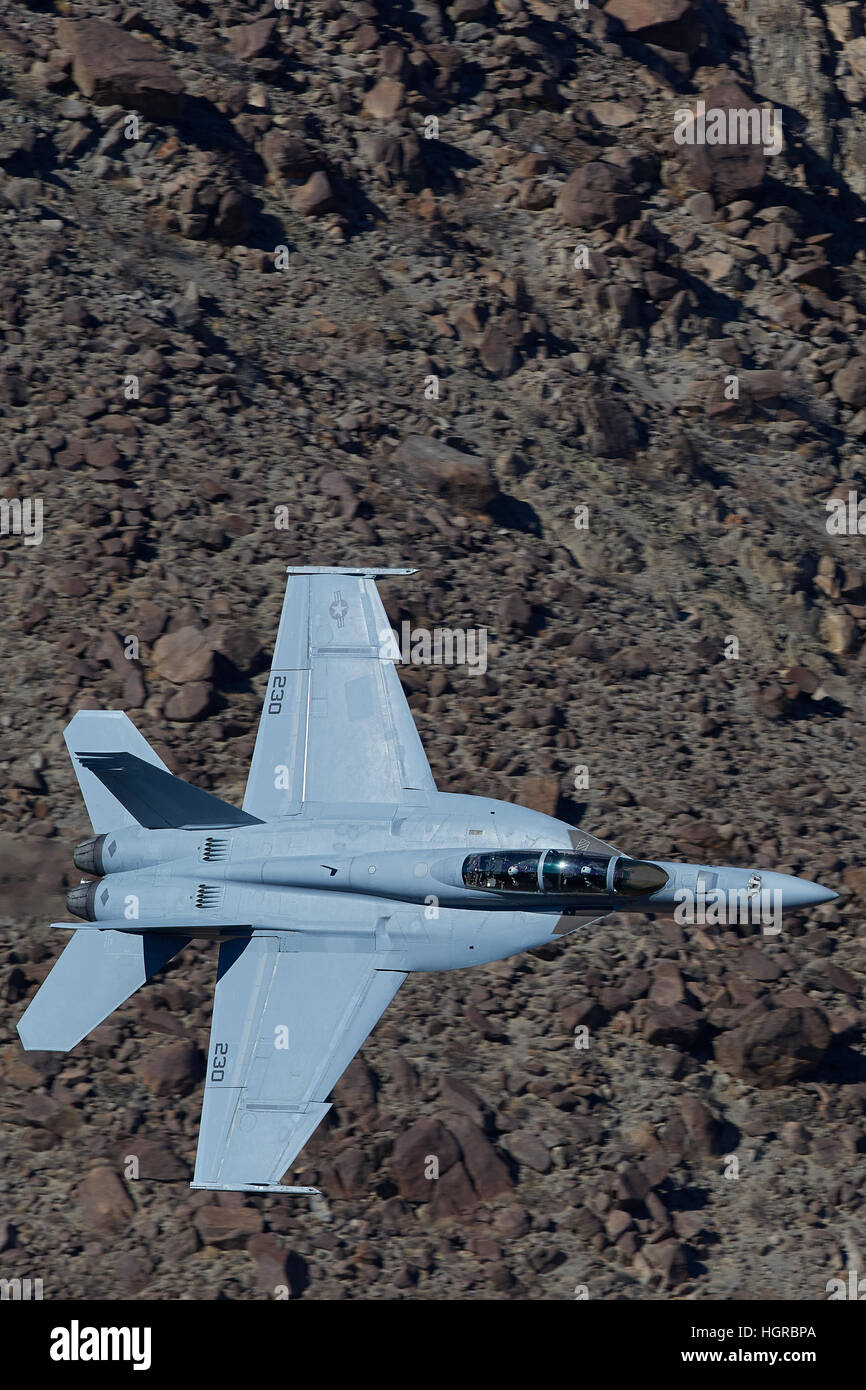 US Navy Super Hornet, F-18F, Flying Through A Desert Canyon In Death Valley National Park, California. Stock Photo