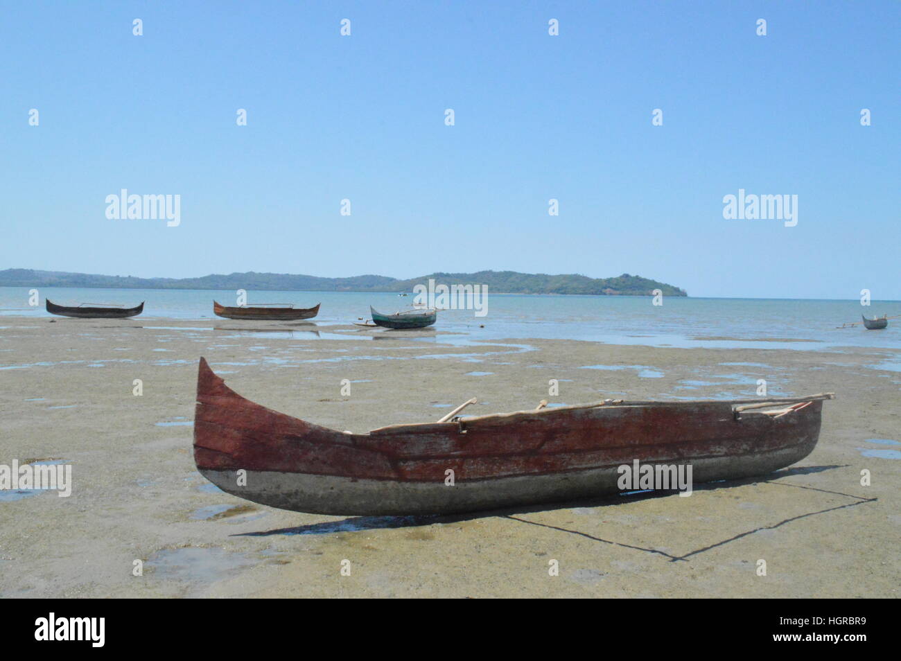 Wooden Pirogues lying idle on the shores of Ambatozavavay in Nosy-Be, Madagascar Stock Photo