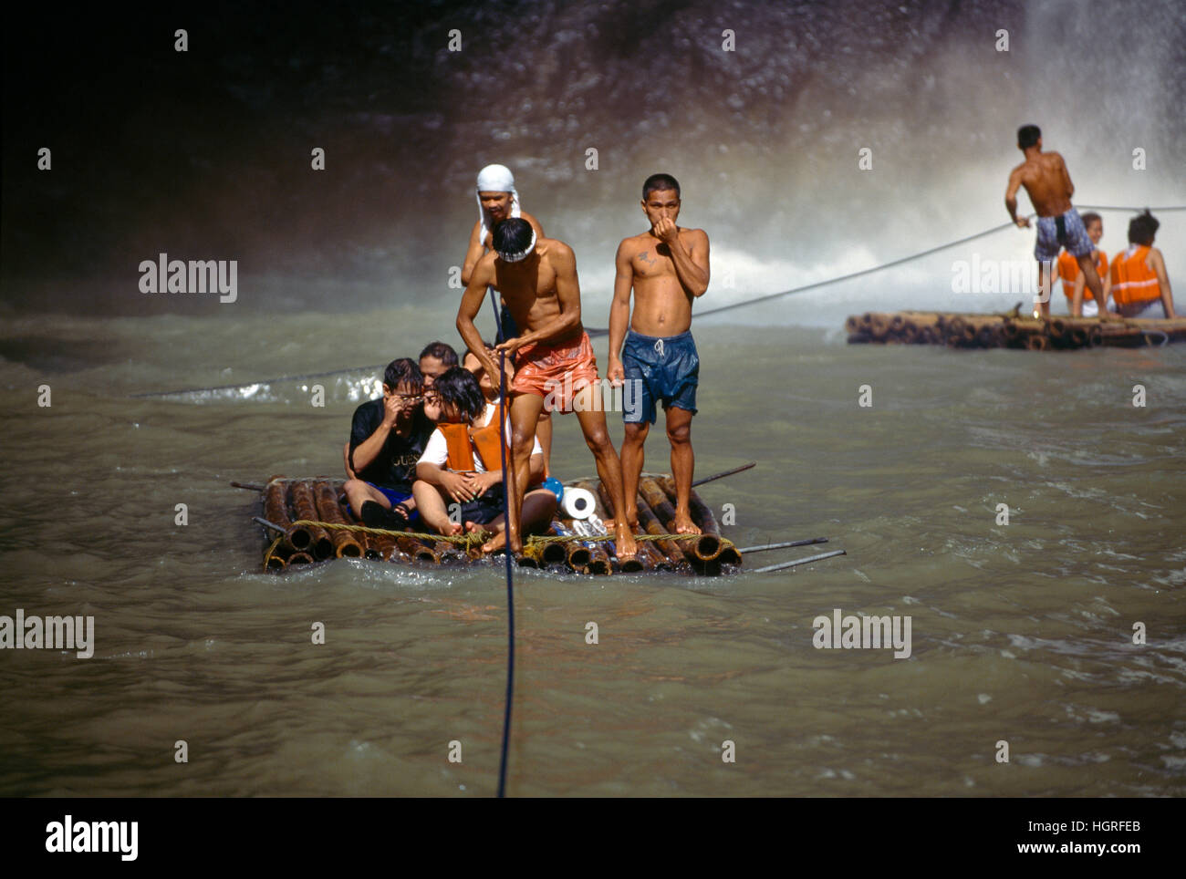 Tourists on Raft Made Of Logs Going Under Waterfall, Pagsanjan, Philippines Stock Photo