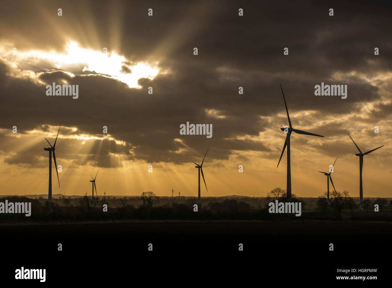 a landscape image of wind turbines at sunset Stock Photo - Alamy