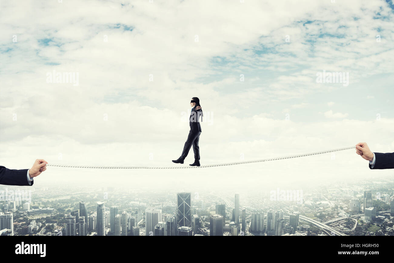 Business concept of risk support and assistance with man balancing on ...
