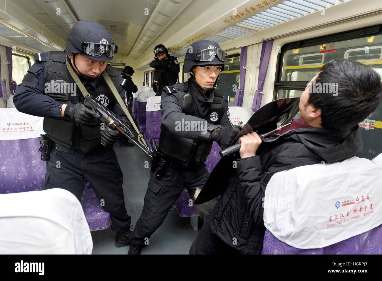 Beijing, China's Ningxia Hui Autonomous Region. 12th Jan, 2017. SWAT policement take part in an anti-riot exercise in a rail yard of the Yinchuan department of Lanzhou Railway Bureau in Yinchuan, capital of northwest China's Ningxia Hui Autonomous Region, Jan. 12, 2017. The exercise was held to improve security capacity for the upcoming Spring Festival travel rush. © Peng Zhaozhi/Xinhua/Alamy Live News Stock Photo
