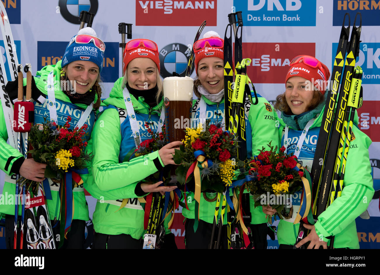 Ruhpolding, Germany. 12th Jan, 2017. L-R: German biathletes Vanessa Hinz, Maren Hammerschmidt, Franziska Preuss and Laura Dahlmeier on the victor's podium after taking first place in the 4 x 6 kilometer women's relay race at the Biathlon World Cup in the Chiemgau Arena in Ruhpolding, Germany, 12 January 2017. Germany finished in first place ahead of France and Norway. Photo: Matthias Balk/dpa/Alamy Live News Stock Photo