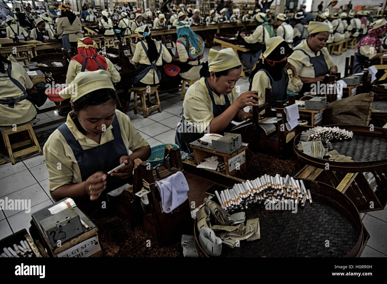 January 6, 2017 - Surabaya, East Java, Indonesia - EAST JAVA, INDONESIA - JANUARY 12 : Indonesian workers handrolling clove cigarettes at Cigarettes factory on January 06, 2017 in Surabaya, East Java, Indonesia. Indonesia is world largets cigarettes produce. (Credit Image: © Sijori Images via ZUMA Wire) Stock Photo