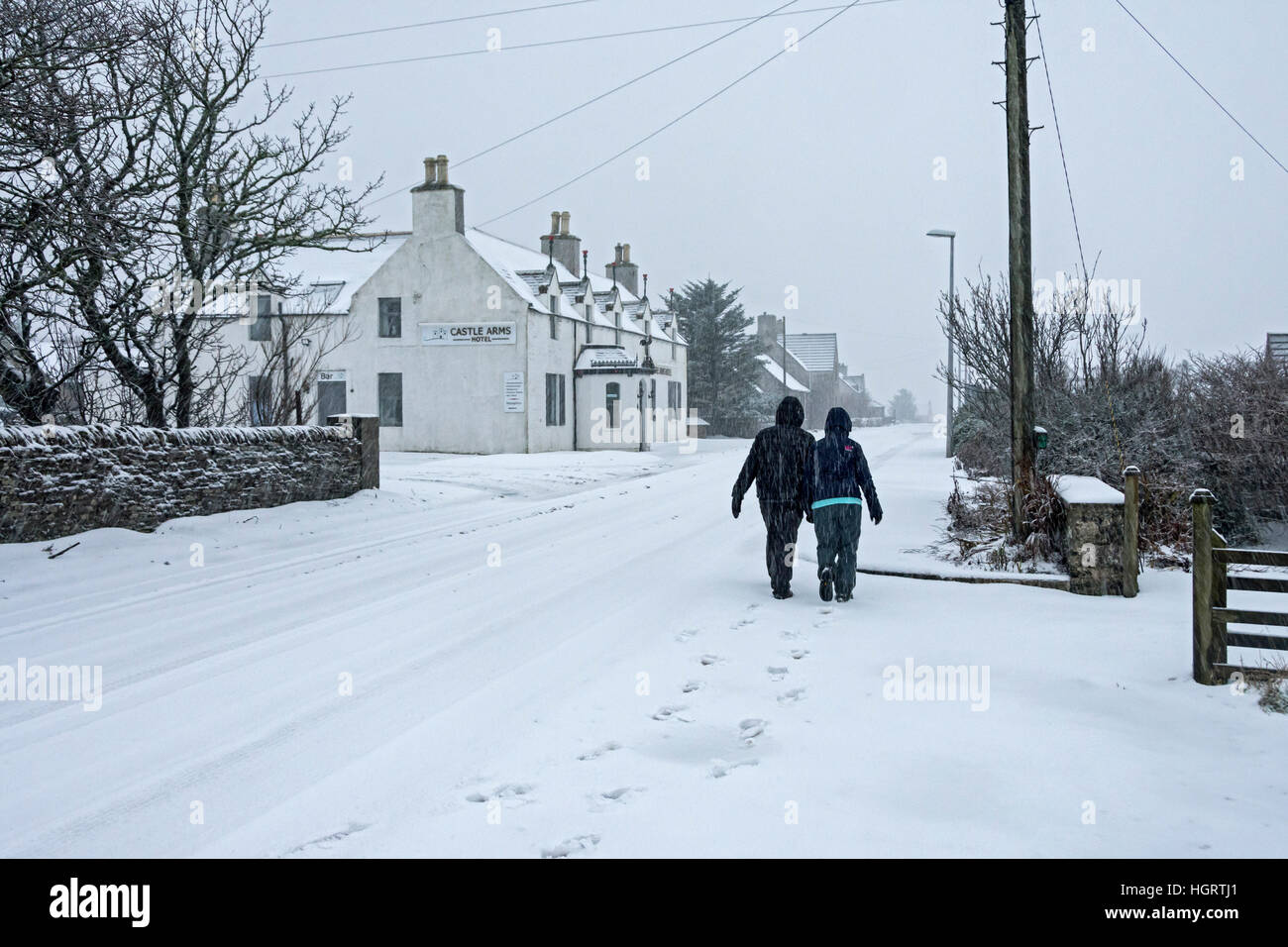 Mey, Caithness, Scotland, 12 Jan 2017. Heavy snow showers merged to give a covering of snow on the A836 road, the main road between Thurso and John o'Groats.  Outside the Castle Arms Hotel in the village of Mey, Caithness, Scotland, UK Stock Photo