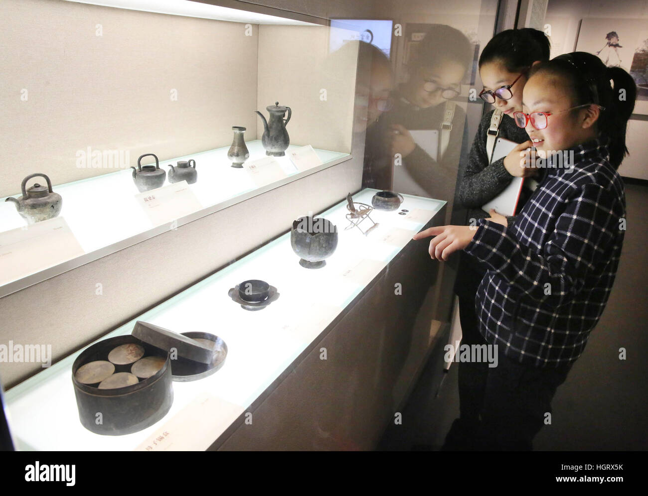 Beijing, China. 12th Jan, 2017. Visitors watch the exhibits during an exhibition of purple clay wares at newly-opened Yixing Museum in Yixing City, east China's Jiangsu Province. The three-month exhibition brought Yixing purple clay wares, which were collected by Beijing's Palace Museum, to their producing place Yixing. The new Yixing Museum with an area of 25,000 square meters opened on Thursday. © Ding Huanxin/Xinhua/Alamy Live News Stock Photo