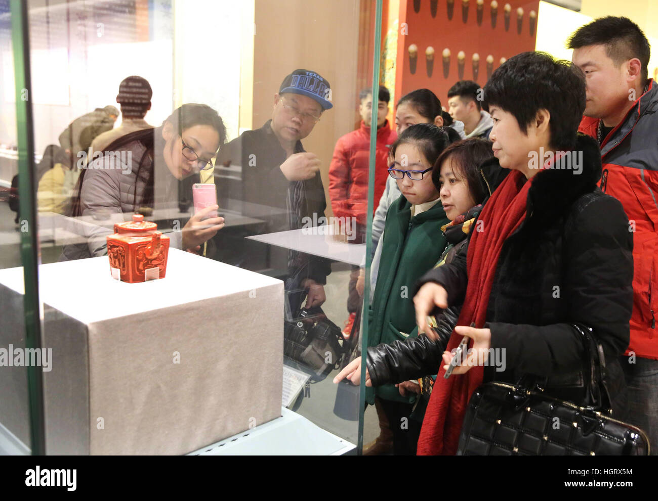 Beijing, China. 12th Jan, 2017. Visitors watch the exhibit during an exhibition of purple clay wares at newly-opened Yixing Museum in Yixing City, east China's Jiangsu Province. The three-month exhibition brought Yixing purple clay wares, which were collected by Beijing's Palace Museum, to their producing place Yixing. The new Yixing Museum with an area of 25,000 square meters opened on Thursday. © Ding Huanxin/Xinhua/Alamy Live News Stock Photo