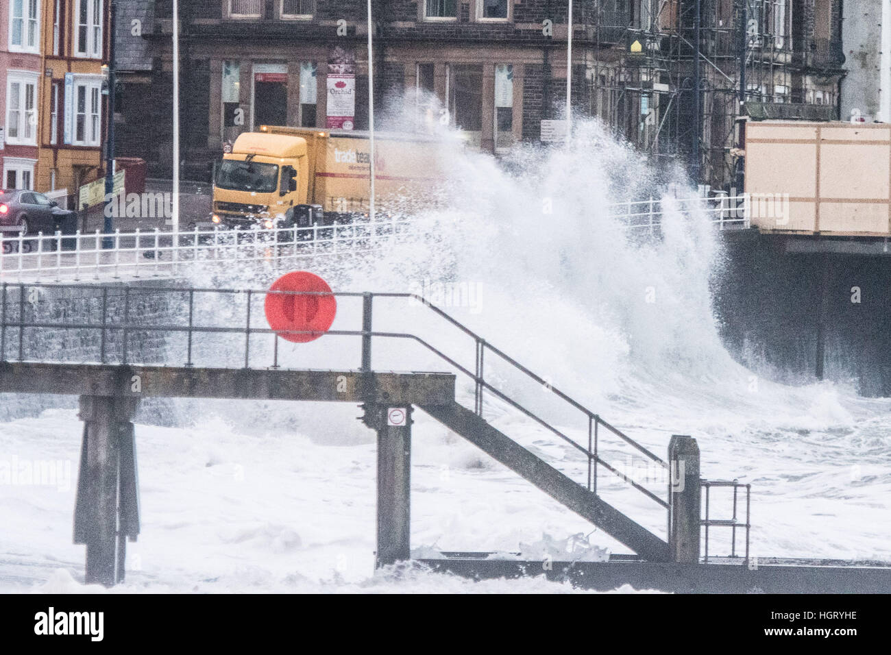 Aberystwyth, Wales, UK.. 13th January 2017. UK Weather: At first light, and with the 5.3m high tide, gale force winds bring monstrous waves crashing against the seafront in Aberystwyth on the Cardigan Bay coast of west Wales photo © Keith Morris/Alamy Live News Stock Photo