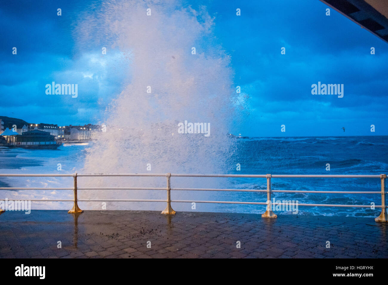 Aberystwyth, Wales, UK.. 13th January 2017. UK Weather: At first light, and with the 5.3m high tide, gale force winds bring monstrous waves crashing against the seafront in Aberystwyth on the Cardigan Bay coast of west Wales photo © Keith Morris/Alamy Live News Stock Photo