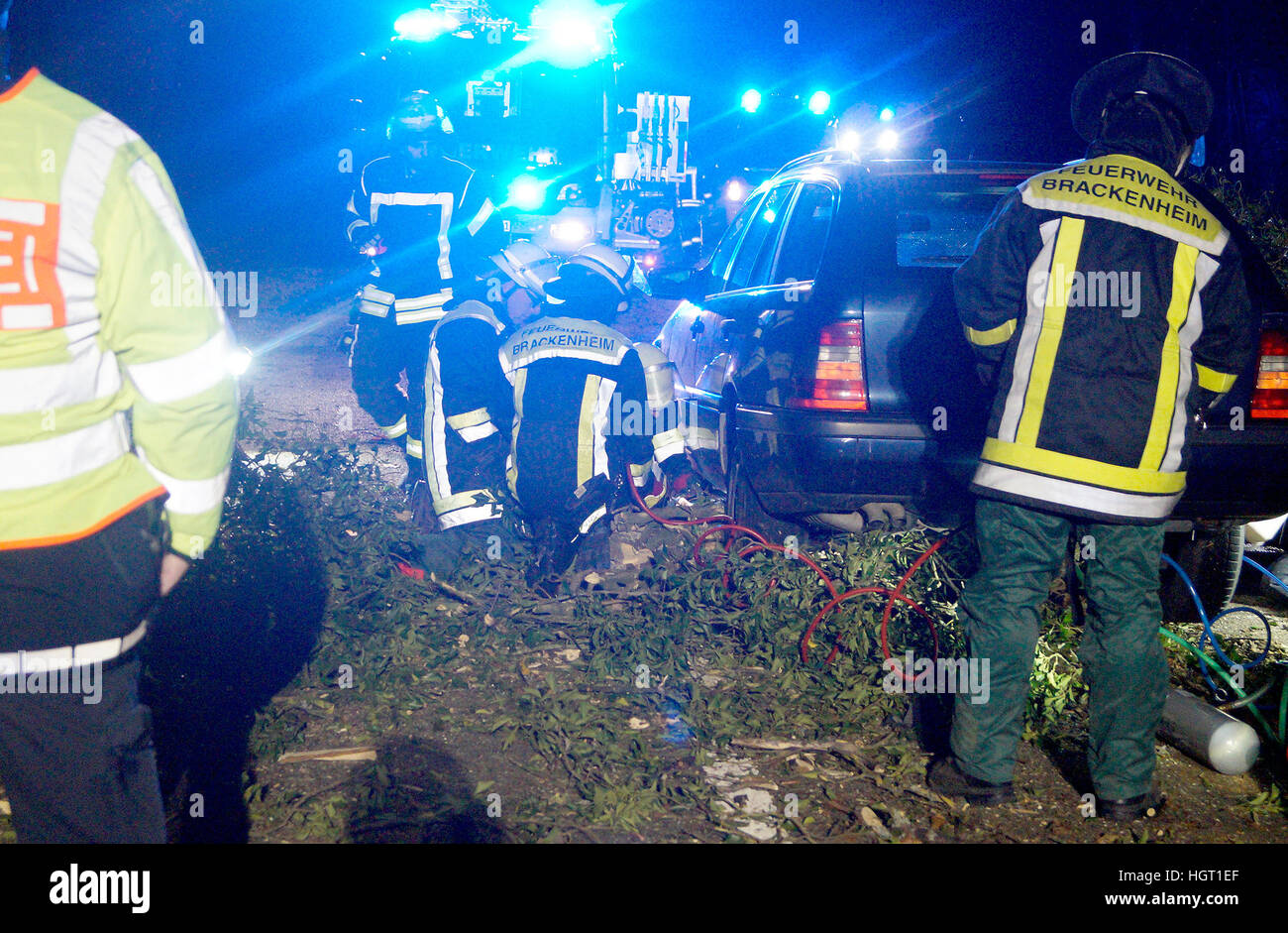 Neipperg, Germany. 13th Jan, 2017. Fire fighters secure a site of an accident on a street near Neipperg, Germany, 13 January 2017. A car hit a tree that had fallen onto the street due to the storm. Photo: Marcel Bartenbach/dpa/Alamy Live News Stock Photo