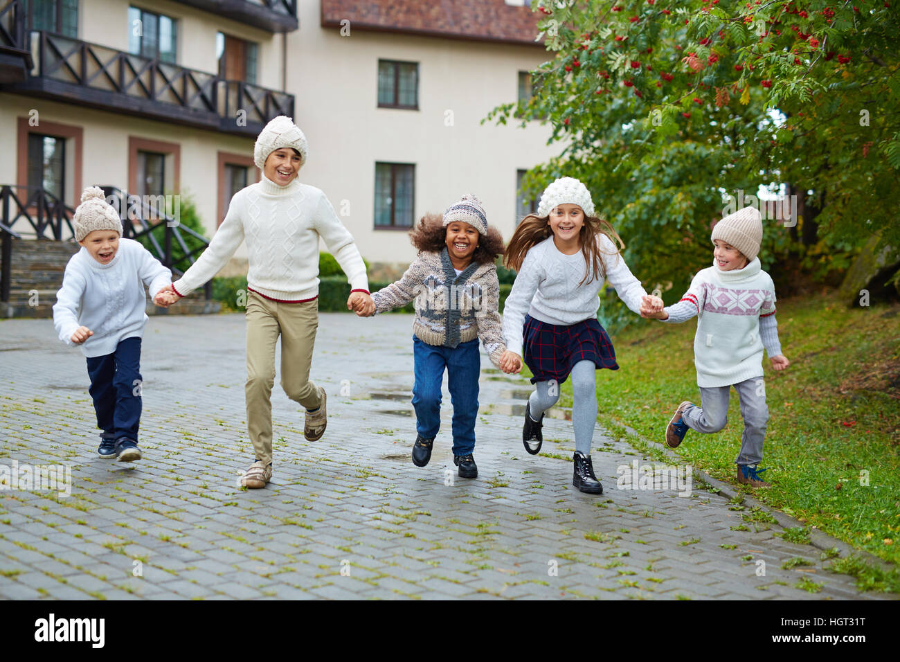 Little classmates running in park by their school Stock Photo - Alamy