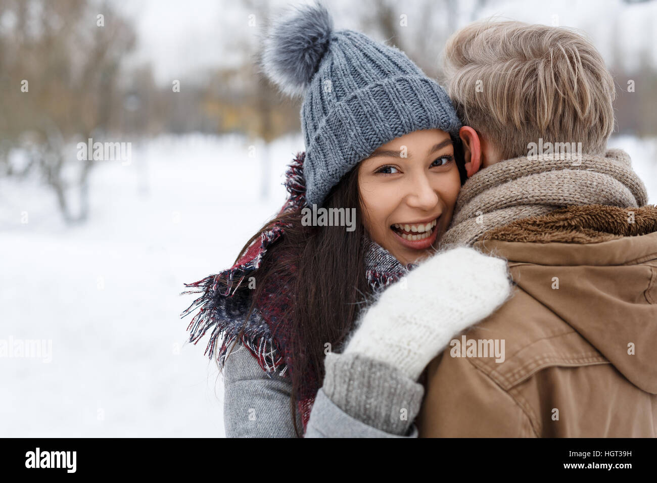 Happy girl in winterwear embracing her boyfriend Stock Photo - Alamy