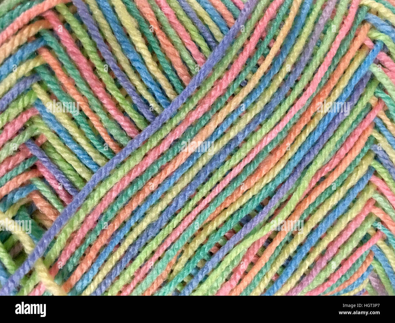 Multi colored yarn in criss cross patter on a skein, background Stock Photo  - Alamy