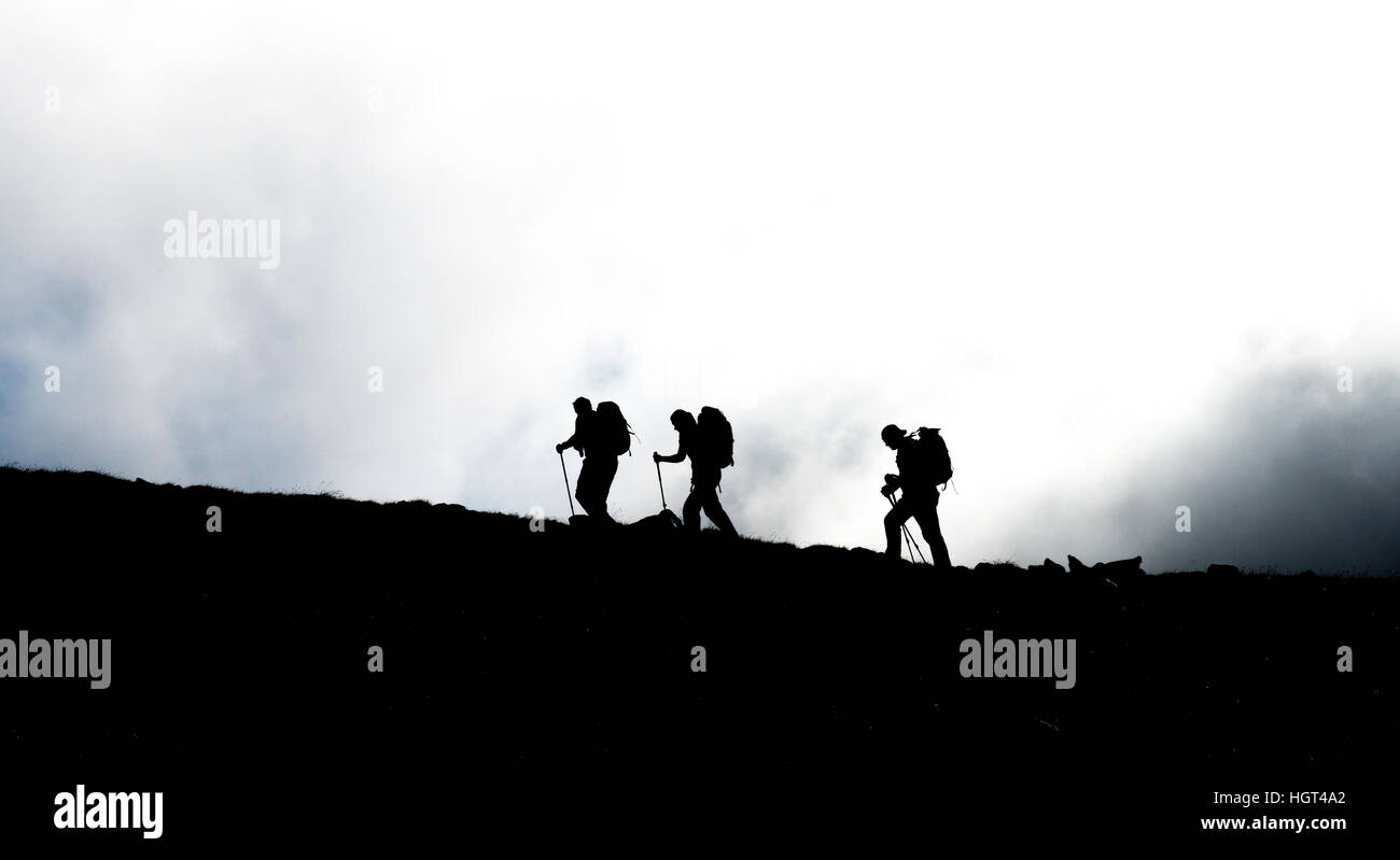 Three hikers on ridge in backlight, Rohrmoos-Untertal, Schladming Tauern, Styria, Austria Stock Photo