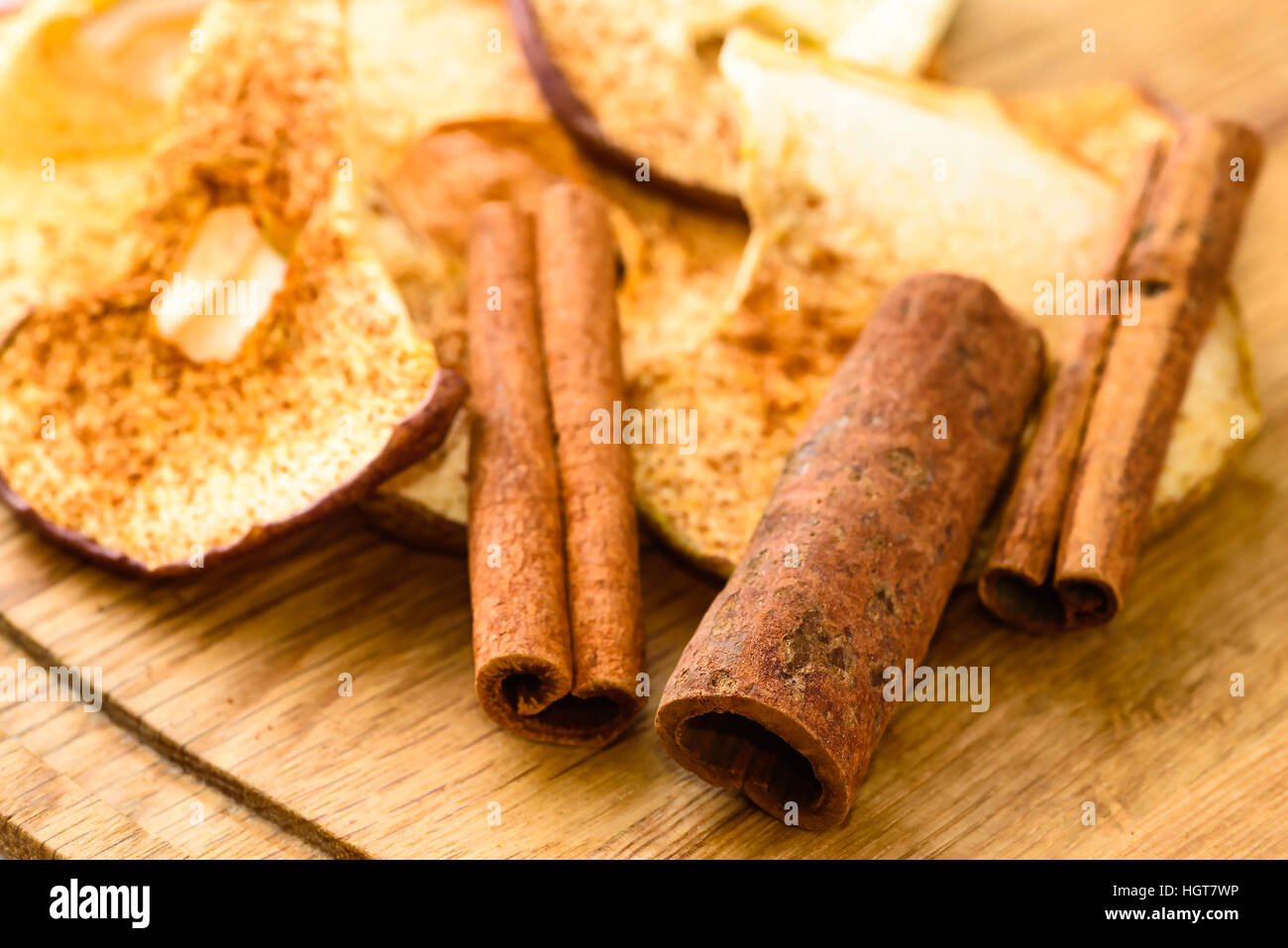 Whole cinnamon and dehydrated apple slices with powdered cinnamon on