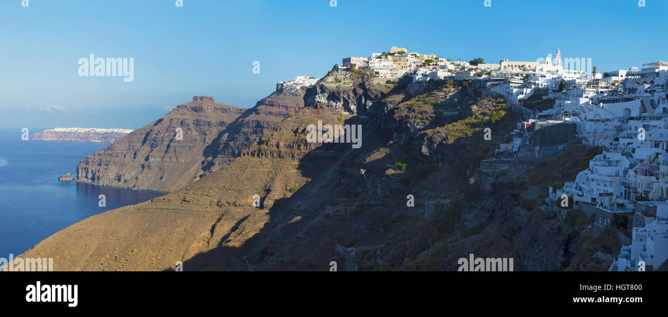 SANTORINI, GREECE - OCTOBER 6, 2015: The Fira and Firostefani in morning light and the Scaros castle, Imerovigli and Oia in background. Stock Photo