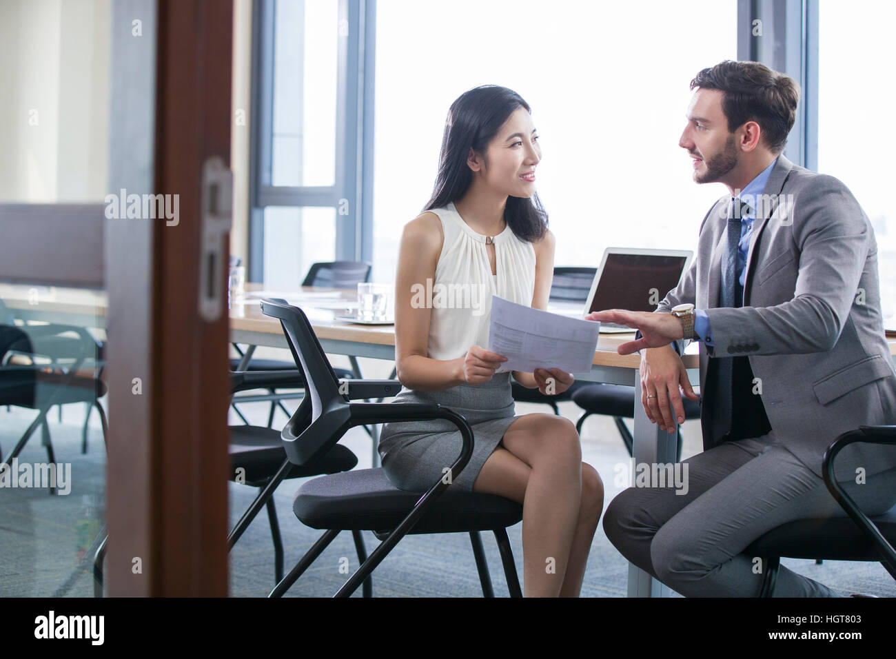 Sitting smiling leadership discussion legs crossed at knee chair hi-res ...