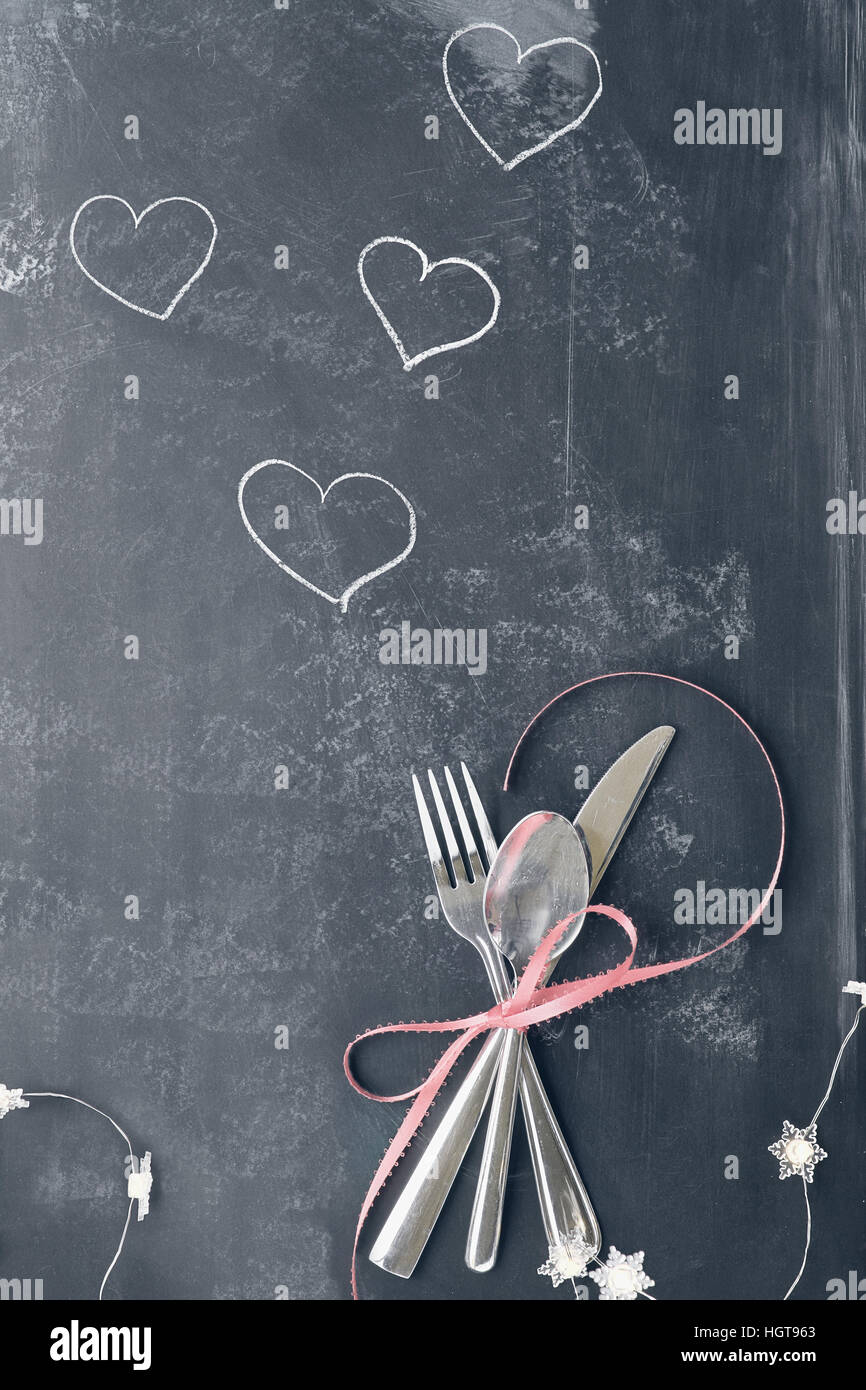 Top view of Valentines day dinner table setting with cutlery over a ... Top view of Valentines day dinner table setting with cutlery over a ...