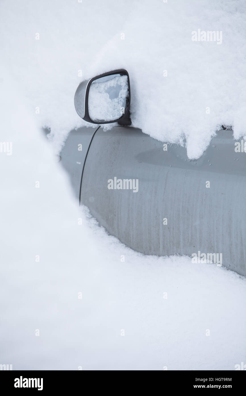 Color image of a parked car mirror, under heavy snow Stock Photo Alamy