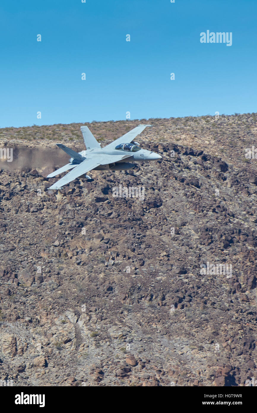 United States Navy Super Hornet, F-18F, Flying Into A Desert Canyon In Death Valley National Park, California. Stock Photo
