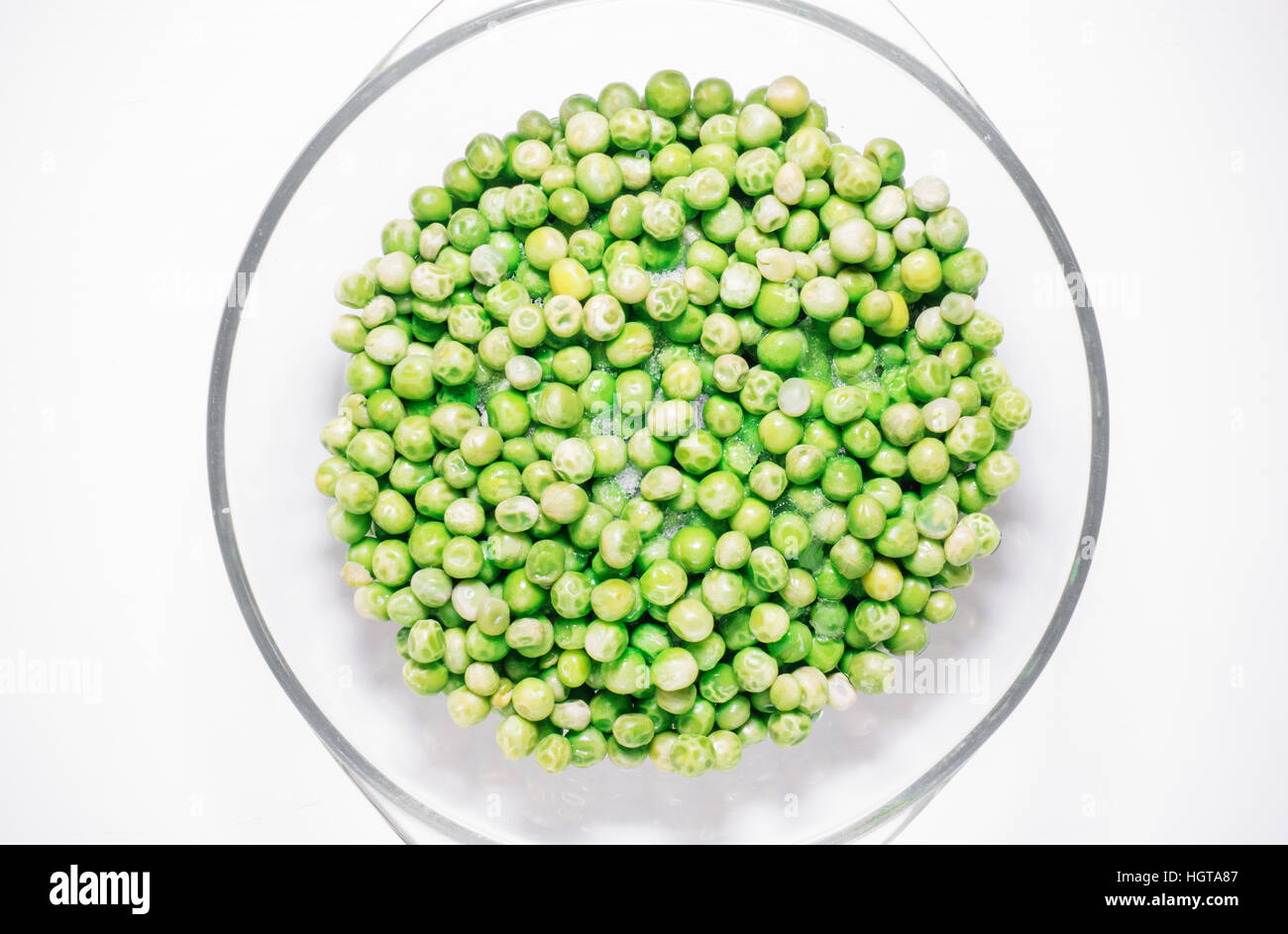 Green sweet peas defrost view from above on a white background Stock Photo