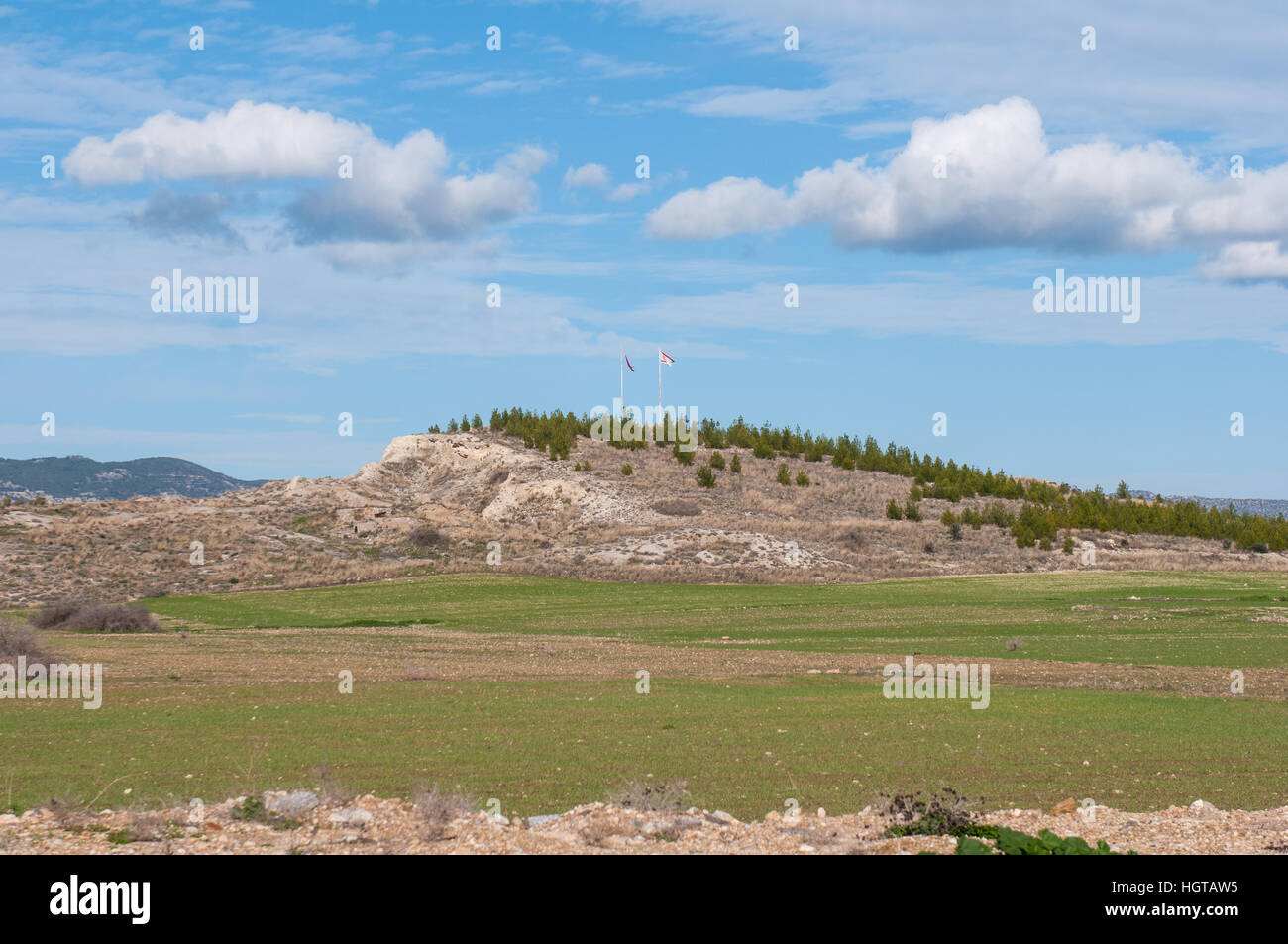 A hill with the Turkish Cypriot flags in the countryside of Buyukkonuk
