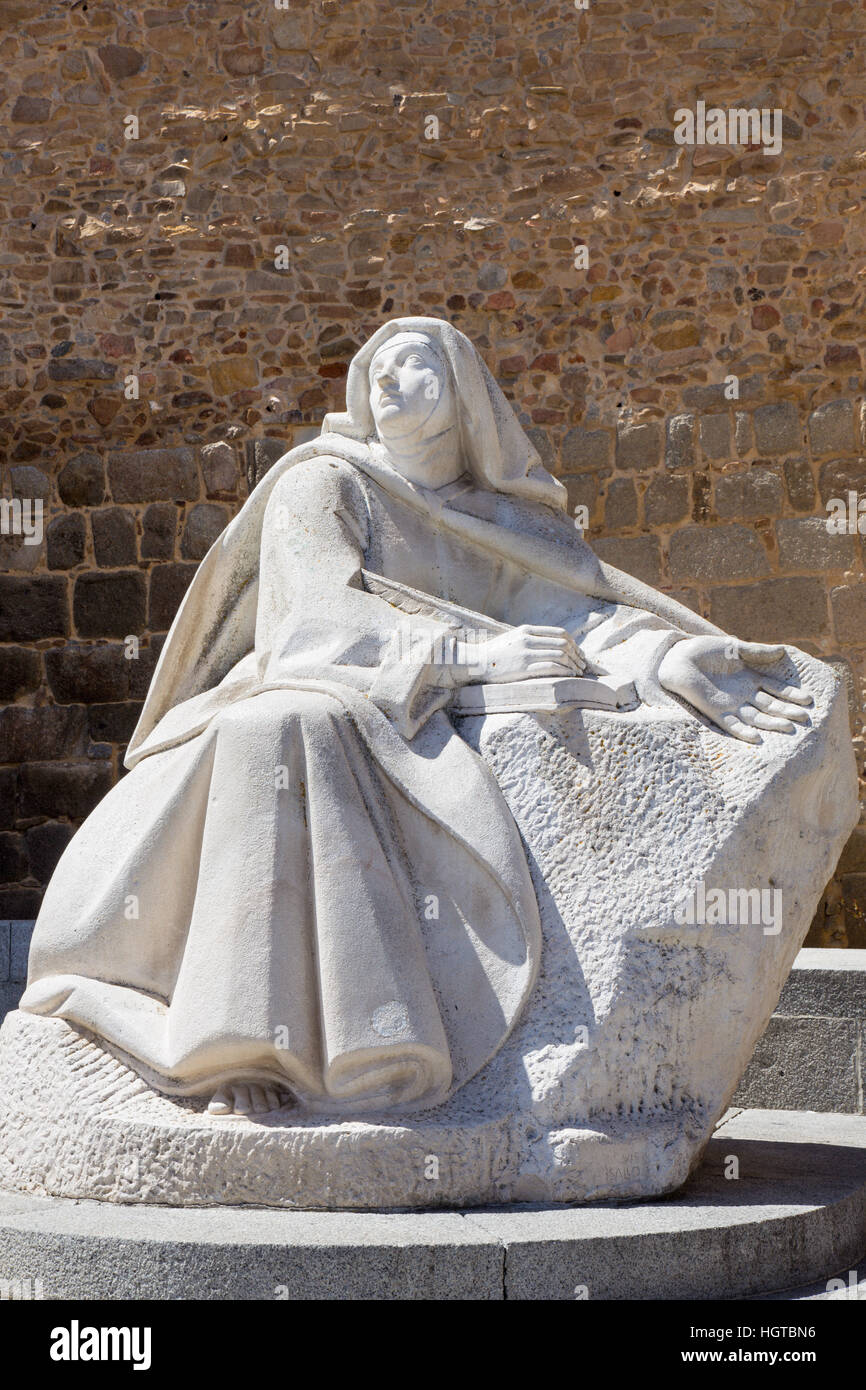AVILA, SPAIN, APRIL - 18, 2016: The statue of St. Theresia of Avila behind the town walls by the Spanish sculptor Juan Luis Vassallo 1972. Stock Photo