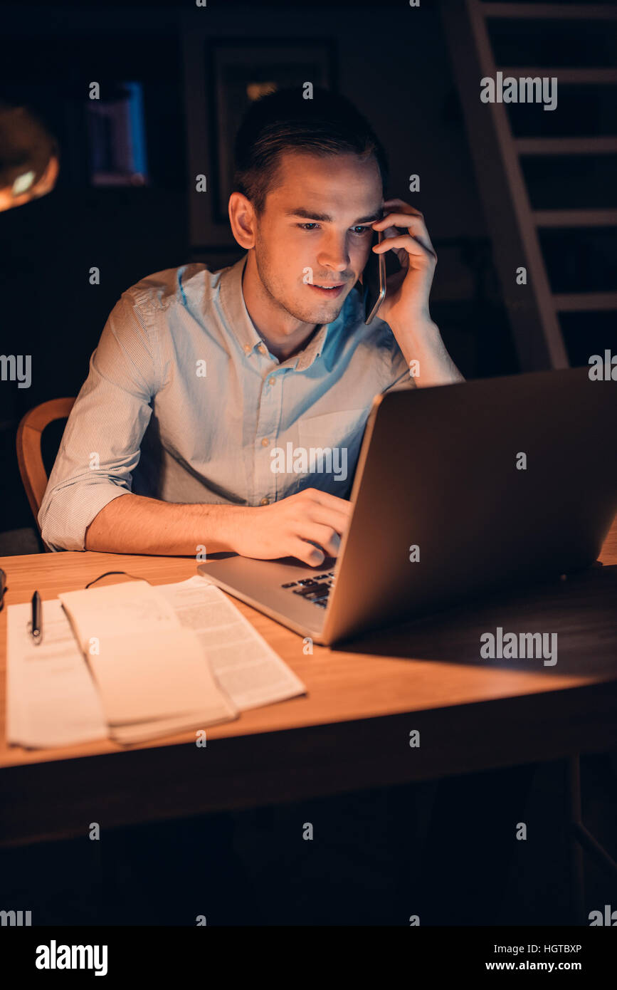 Young businessman hard at work late in the evening Stock Photo