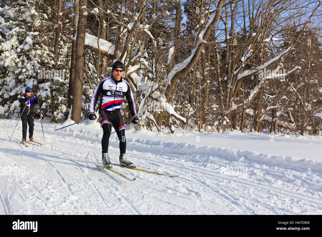 A man and woman crosscountry skiing at the Notchview Reservation in