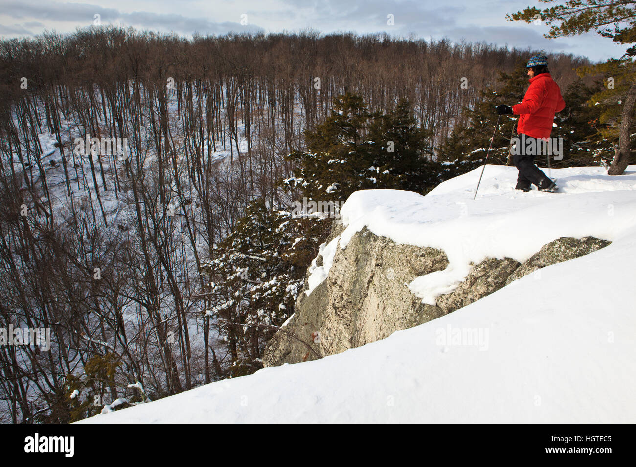 A man snowshoeing on Pony Mountain at the Chapel Brook Reservation in