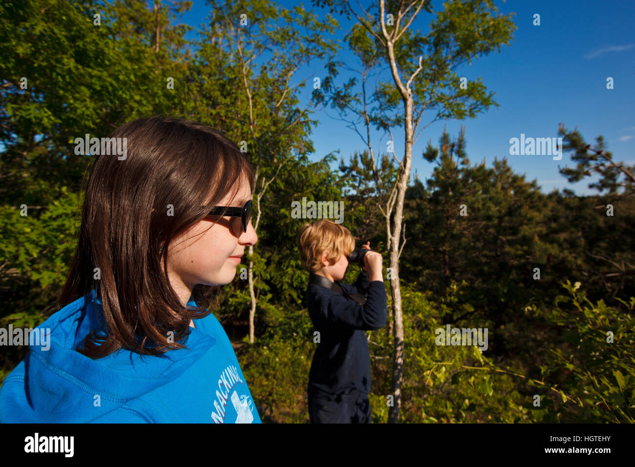 A young boy and girl take in the view from the Biddle Property in Wellfleet, Massachusetts. Cape Cod National Seacshore. Stock Photo
