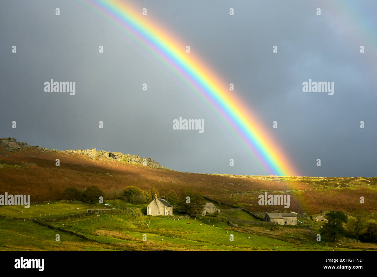 Rainbow appears during storm in the Peak District Derbyshire countryside Stock Photo