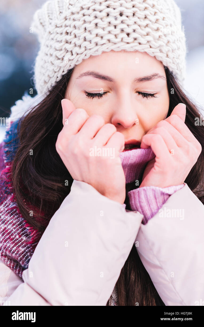 Girl freezing on a could winter day Stock Photo