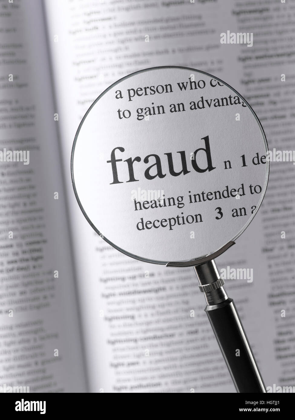 Magnifying glass highlighting fraud Stock Photo