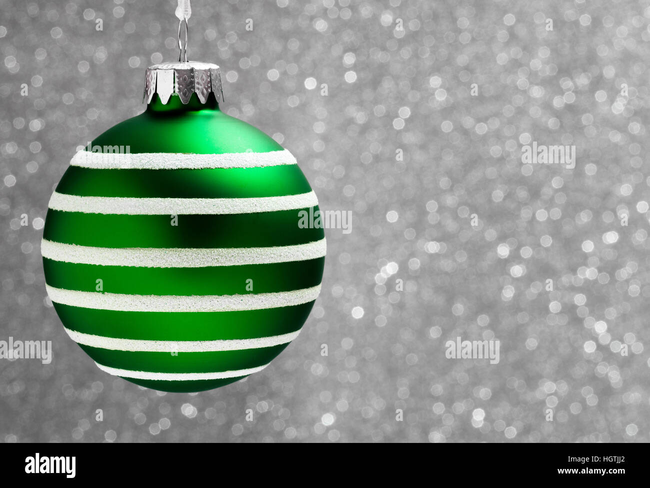 Christmas Bauble Decoration hanging with a silver background Stock Photo
