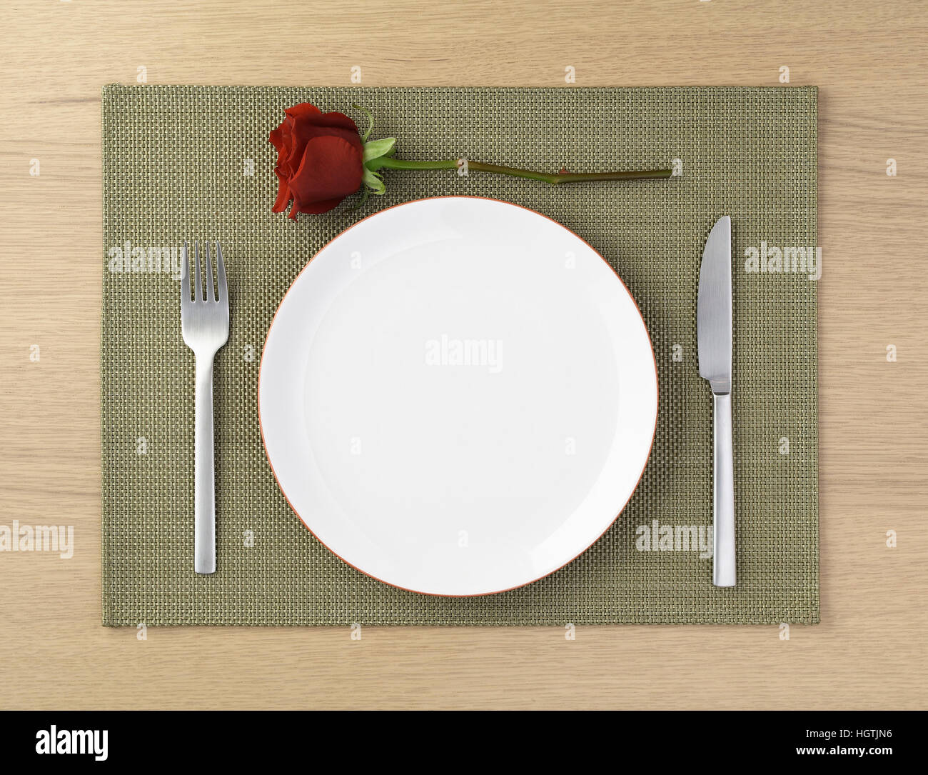 Table Setting With A Red Rose On A Place Mat Ready To Go Stock
