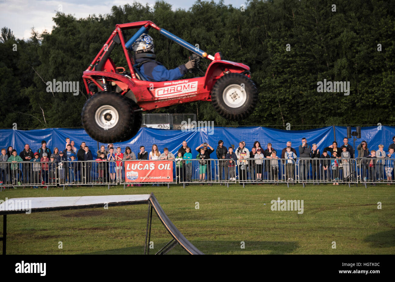 Car driver performing daring aerial stunt. Stock Photo