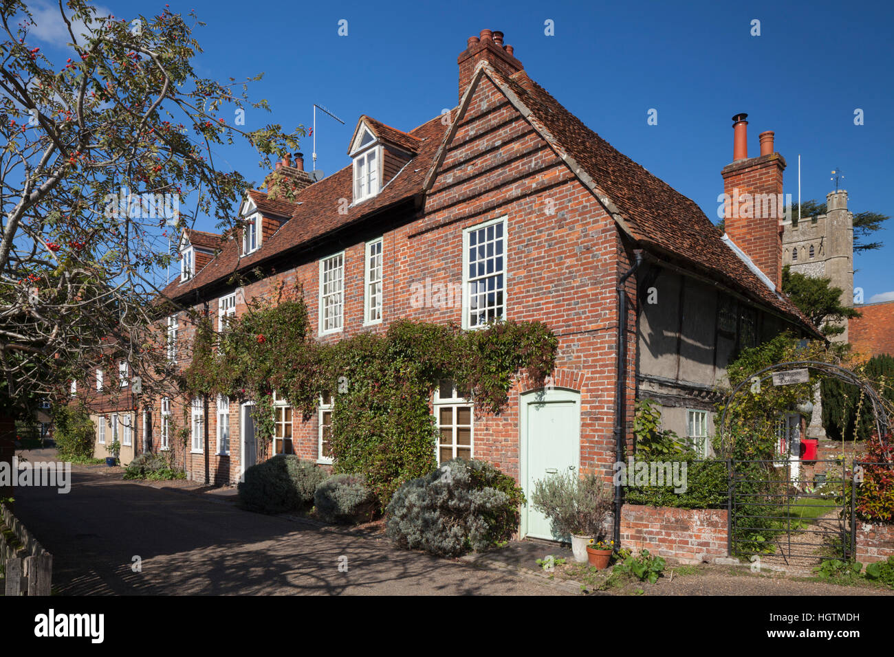 A row of cottages and the church of St Mary the Virgin in the Chiltern Hills village of Hambleden, Hambleden Valley, Buckinghamshire, England, UK Stock Photo