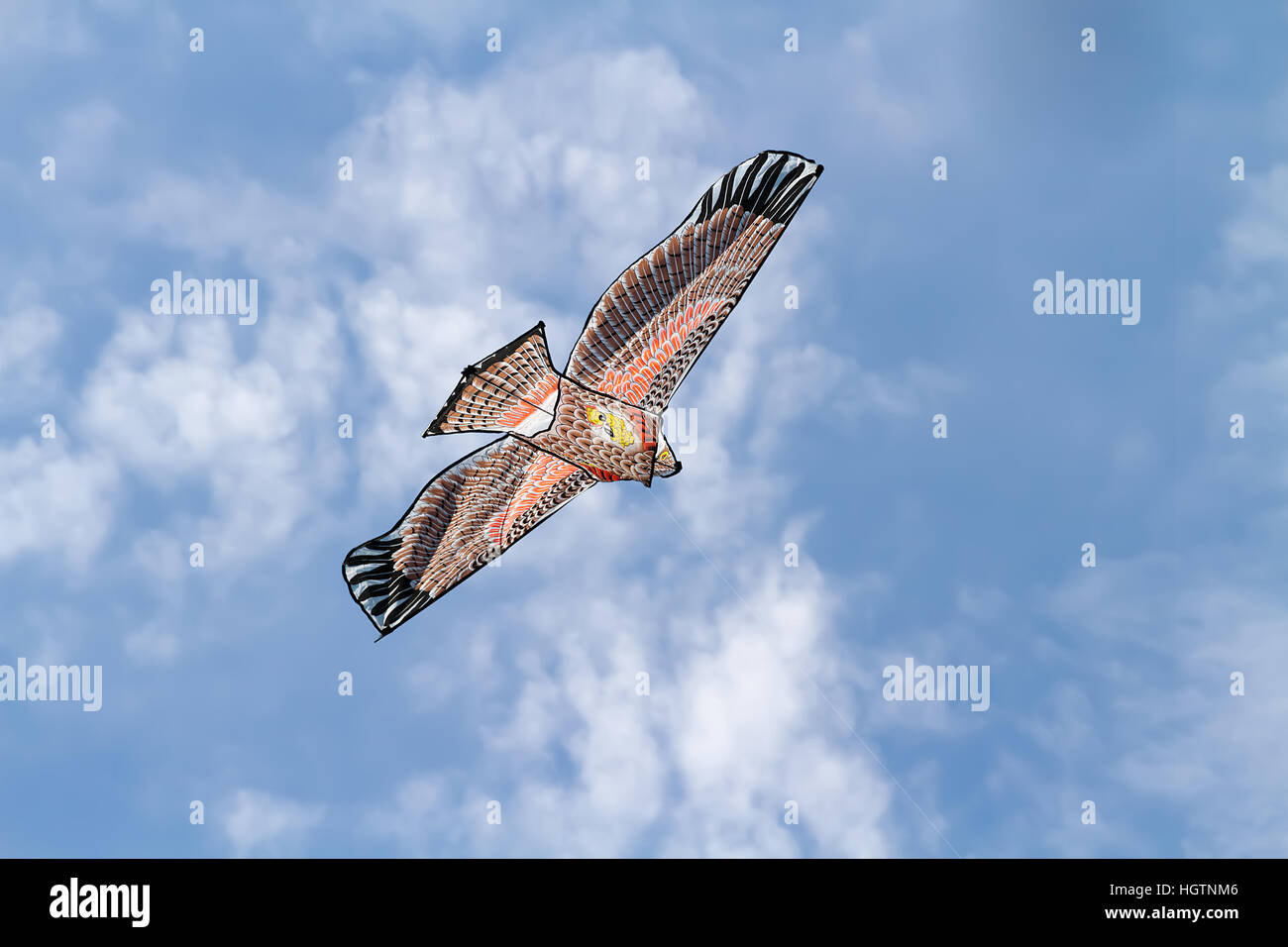 Kite flying against a blue sky background Stock Photo - Alamy