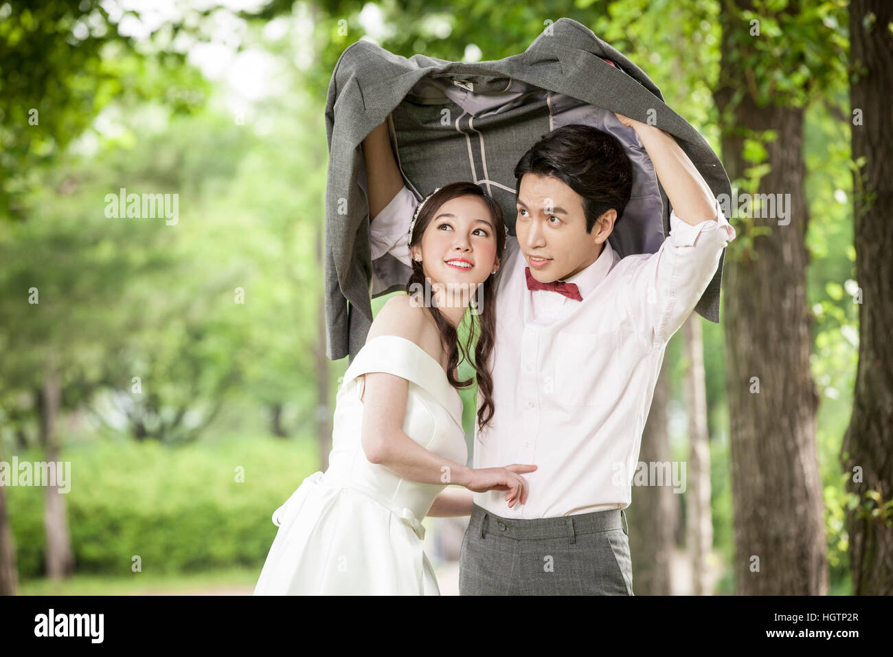 Young romantic wedding couple posing outdoors Stock Photo - Alamy