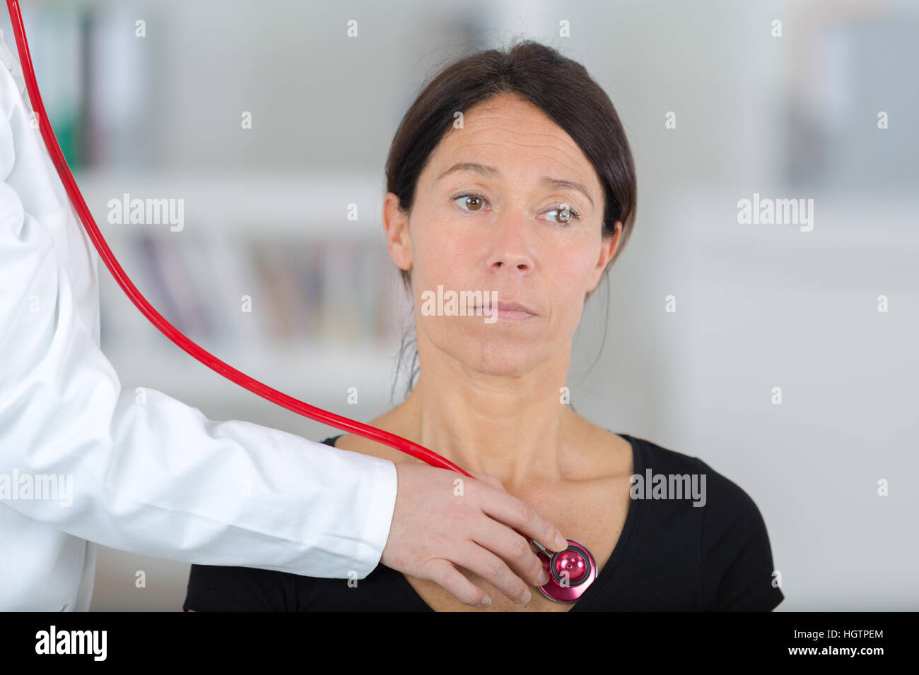 female doctor examining the patient with stethoscope Stock Photo - Alamy