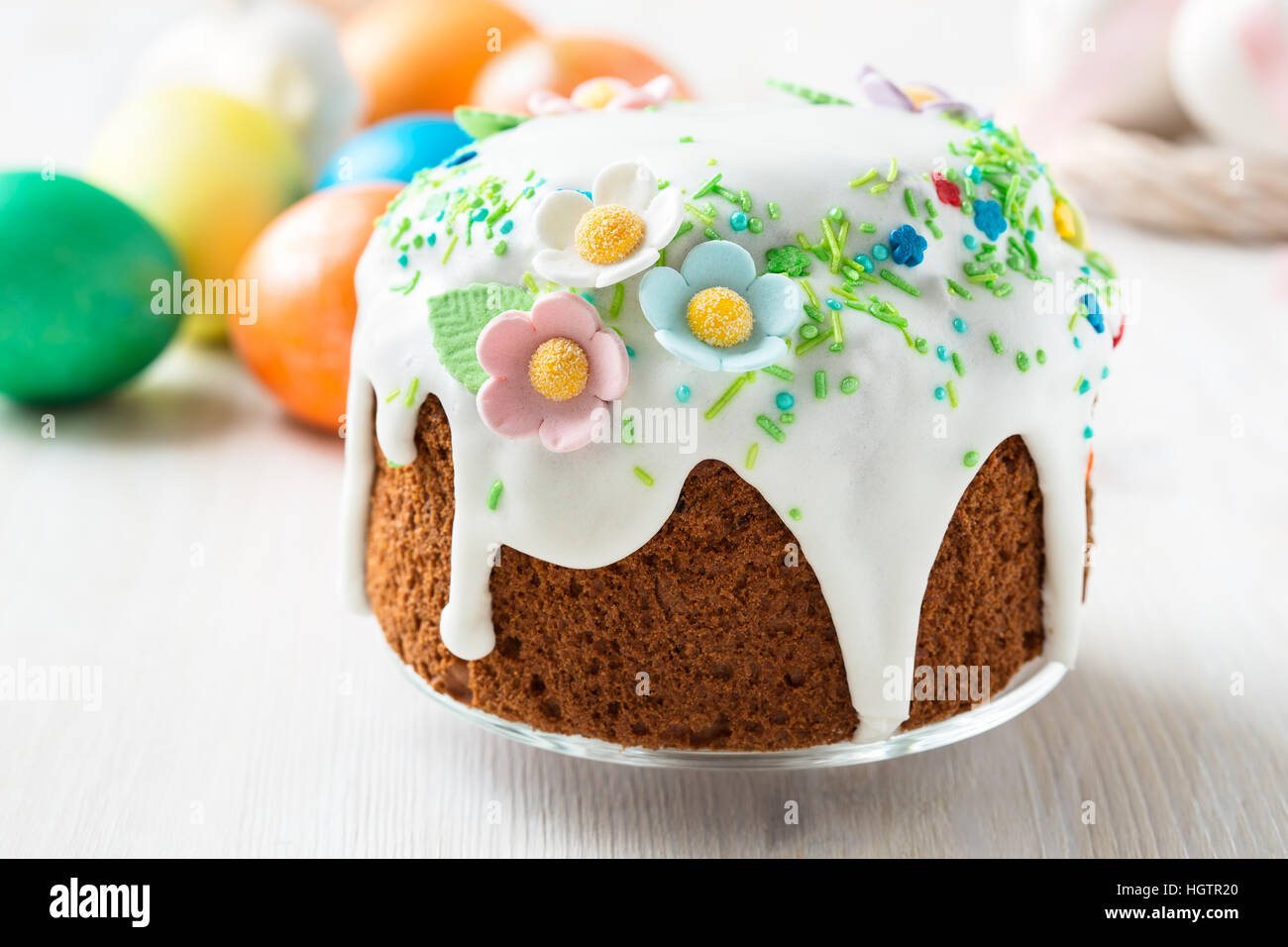 Easter cake with glace icing decoration and coloured easter eggs on a