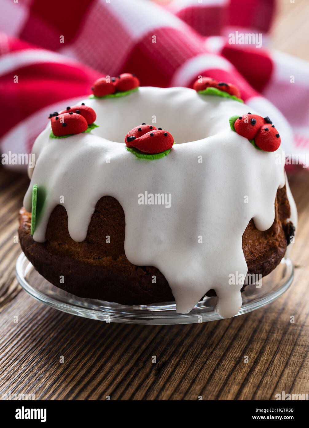 Easter sweet ring cake with glace icing and decoration on rustic wooden  table Stock Photo - Alamy