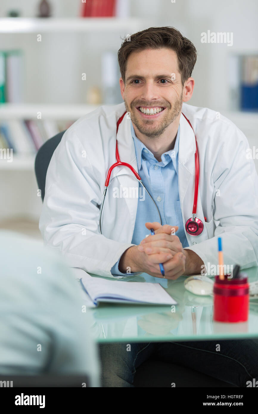 portrait of an handsome doctor smiling Stock Photo - Alamy