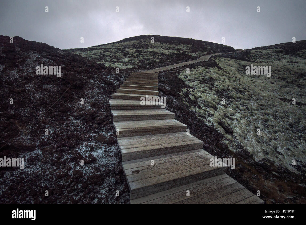Winding wooden pathway at the Grábrók Crater, cinder cones in west Iceland. Stock Photo