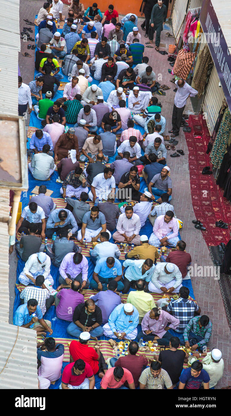 Mosque Party Muslim men gathering for a communal charity iftar organised on a street ...