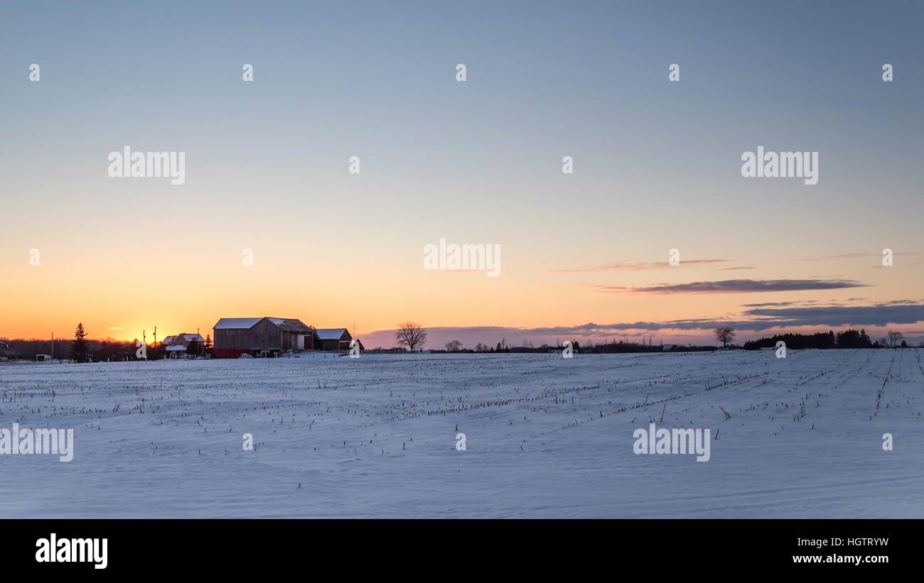 Winter Sunset Over A Farm In Winter Stock Photo - Alamy