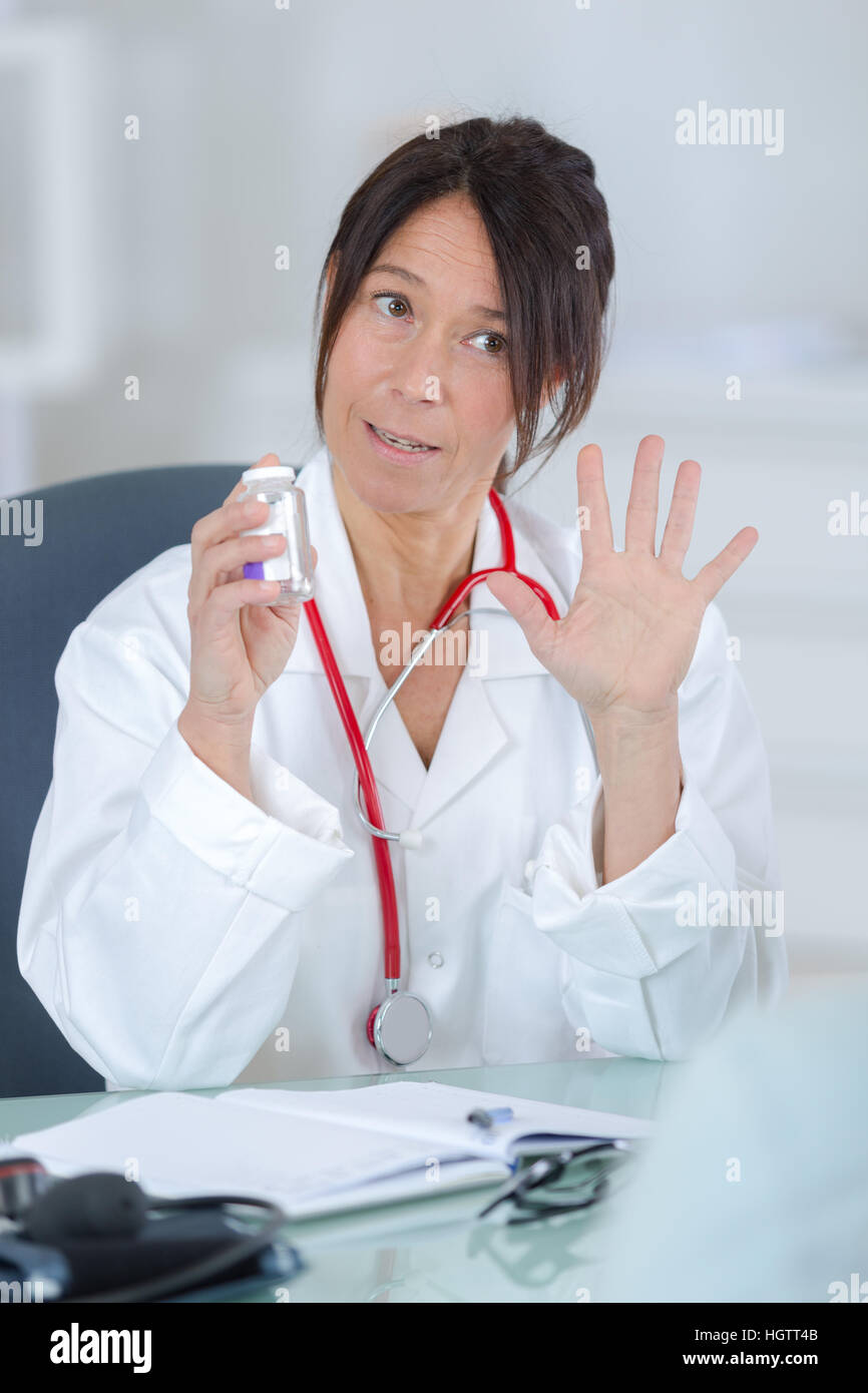 female brunette doctor posing for the camera wearing stethoscope Stock Photo